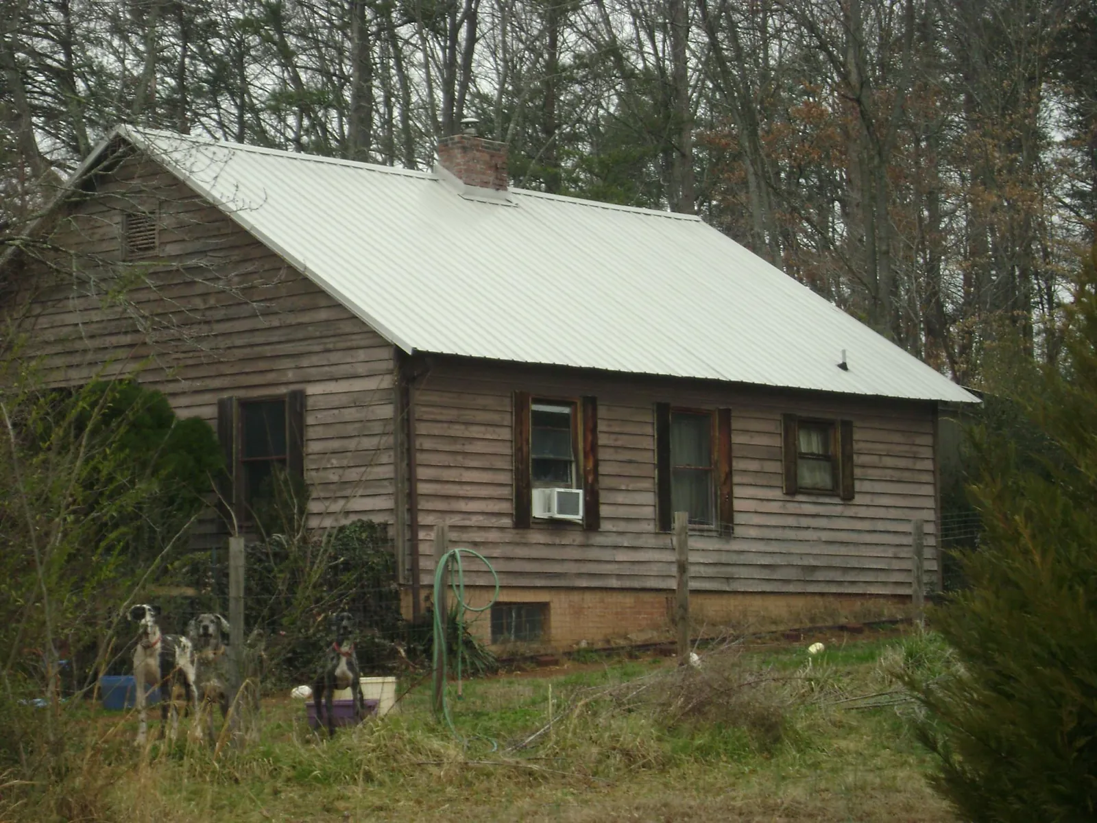 White metal roof on an old wood sided farmhouse, from a Asphalt Shingle Roof Repair job in Manassas